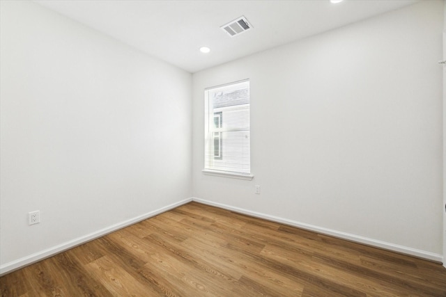 unfurnished room featuring hardwood / wood-style flooring