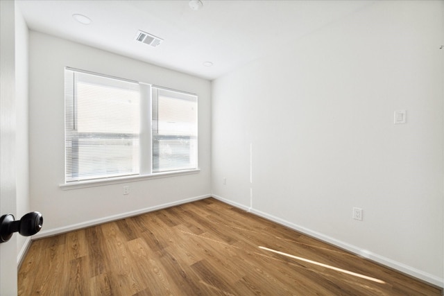 empty room with hardwood / wood-style floors