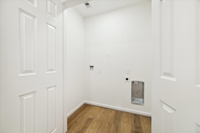 laundry area with light hardwood / wood-style floors and hookup for an electric dryer