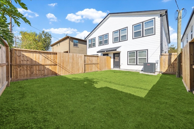 back of property featuring a lawn and cooling unit