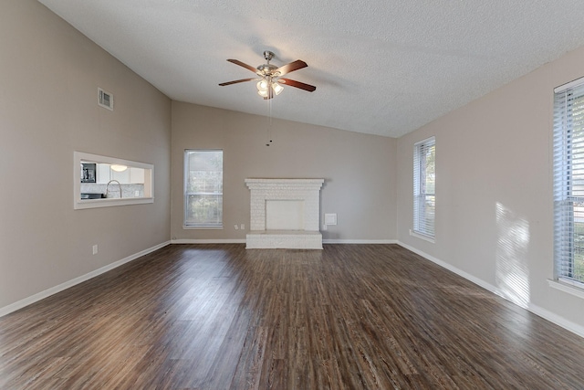 unfurnished living room featuring dark hardwood / wood-style floors, a wealth of natural light, and vaulted ceiling