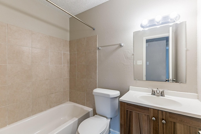 full bathroom with vanity, a textured ceiling, toilet, and tiled shower / bath combo