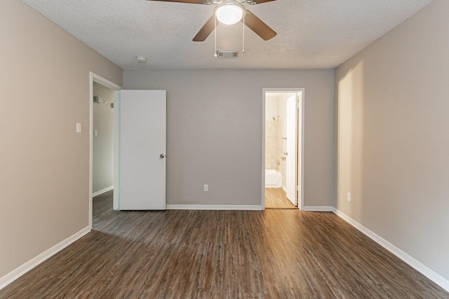 unfurnished bedroom featuring connected bathroom, ceiling fan, dark hardwood / wood-style flooring, and a textured ceiling