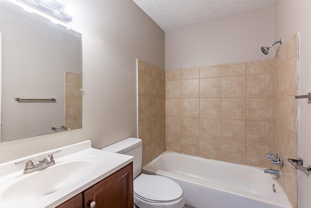 full bathroom featuring toilet, vanity, a textured ceiling, and tiled shower / bath combo