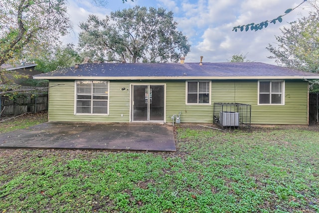 rear view of property with a patio area and central air condition unit