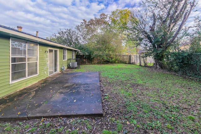 view of yard featuring a patio and central AC unit