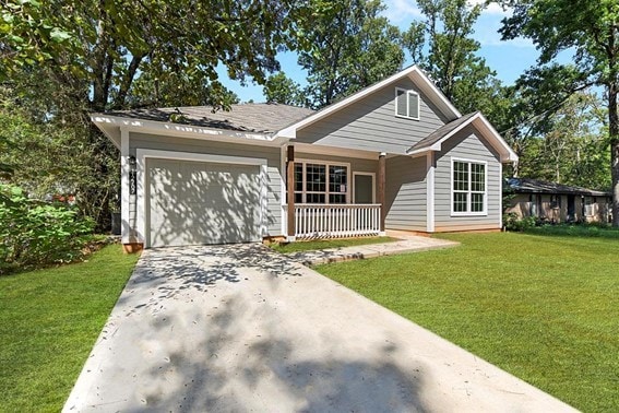 view of front facade featuring a porch, a garage, and a front yard