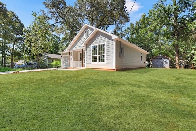 view of front of house with a porch, a front lawn, and a shed