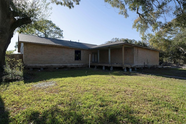 rear view of property with a lawn