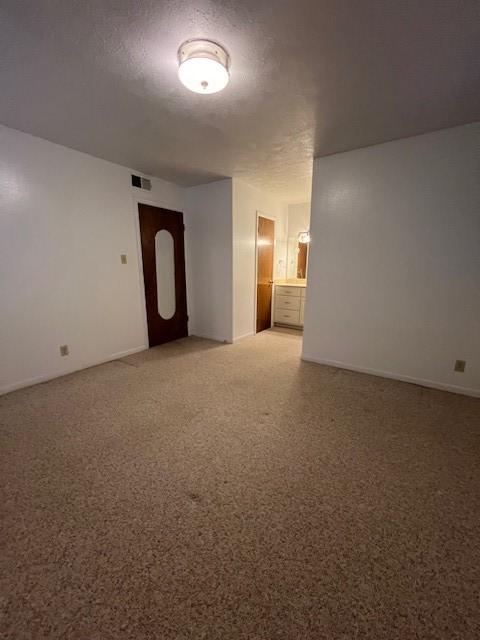 empty room with a textured ceiling