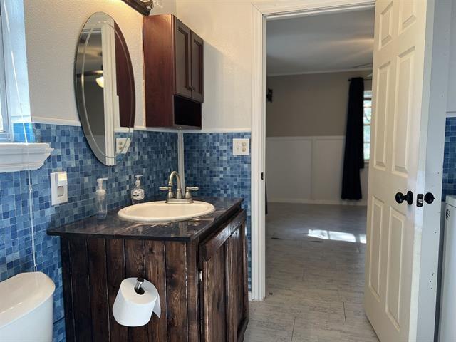 bathroom featuring vanity, toilet, and tile patterned flooring