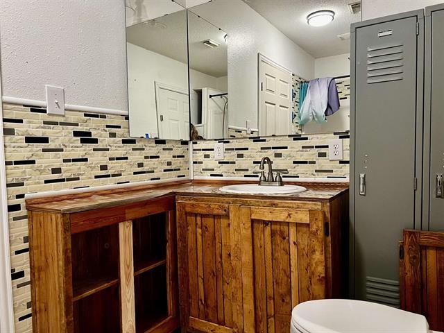 bathroom featuring vanity and toilet