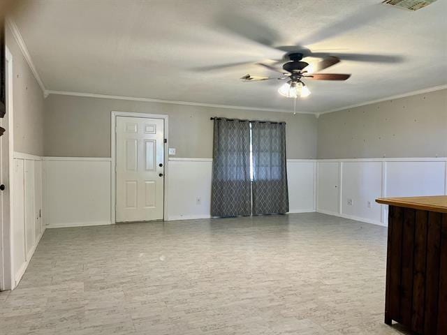 spare room with crown molding, ceiling fan, and light hardwood / wood-style flooring