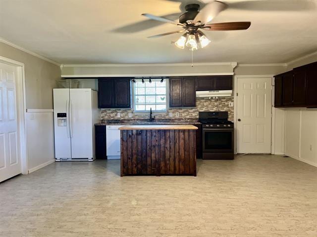 kitchen featuring backsplash, white appliances, dark brown cabinetry, and ornamental molding