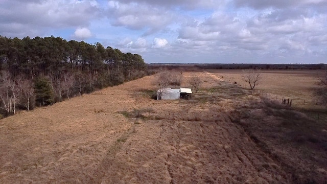 entry to storm shelter with a rural view