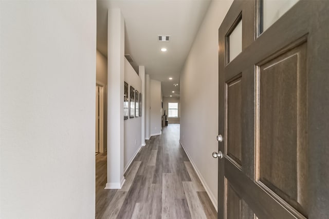 hall with hardwood / wood-style floors