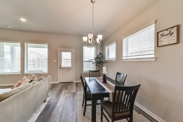 dining space featuring a notable chandelier, plenty of natural light, and dark hardwood / wood-style floors