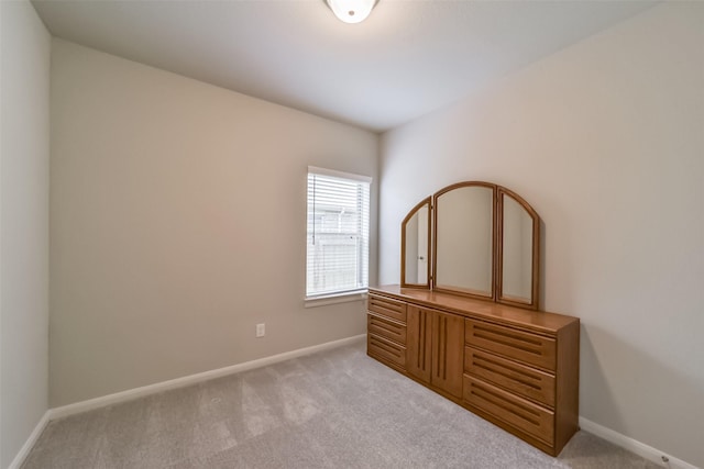 unfurnished bedroom with light colored carpet