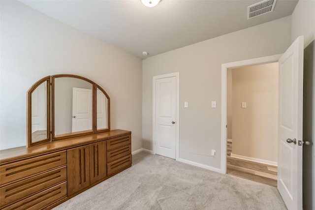 unfurnished bedroom with light colored carpet