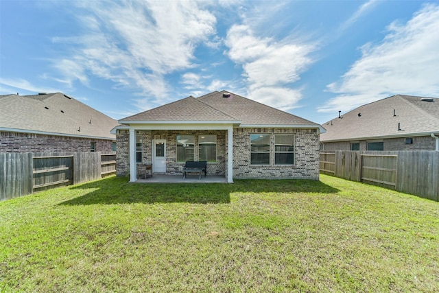 rear view of property featuring a patio area and a yard