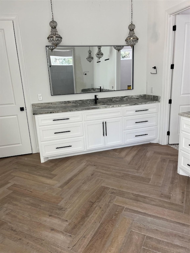 bathroom with vanity and parquet flooring