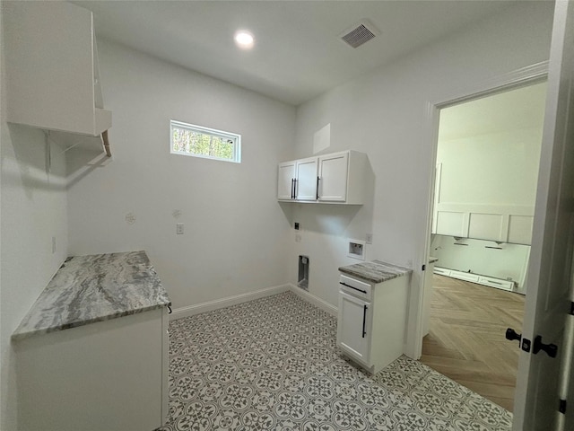 clothes washing area with light parquet floors, electric dryer hookup, hookup for a washing machine, cabinets, and a baseboard radiator