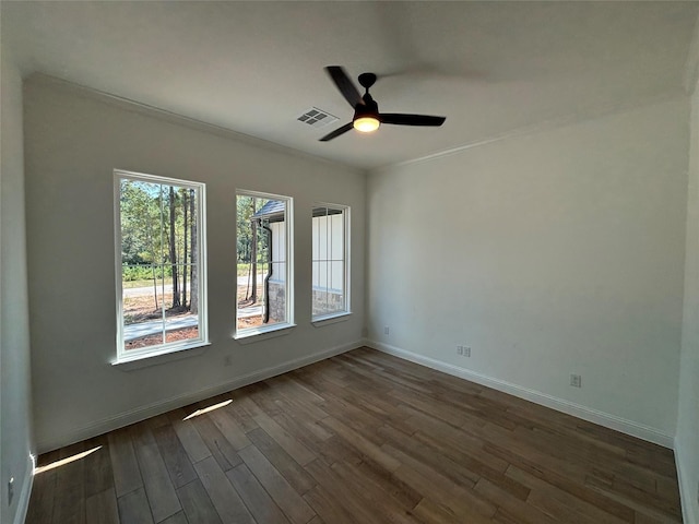 unfurnished room with crown molding, dark hardwood / wood-style floors, and ceiling fan