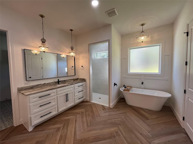 bathroom with vanity, parquet flooring, and plus walk in shower