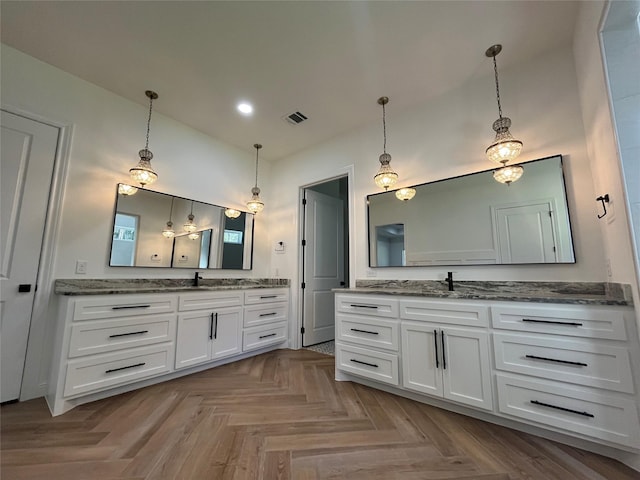 bathroom featuring vanity and parquet flooring