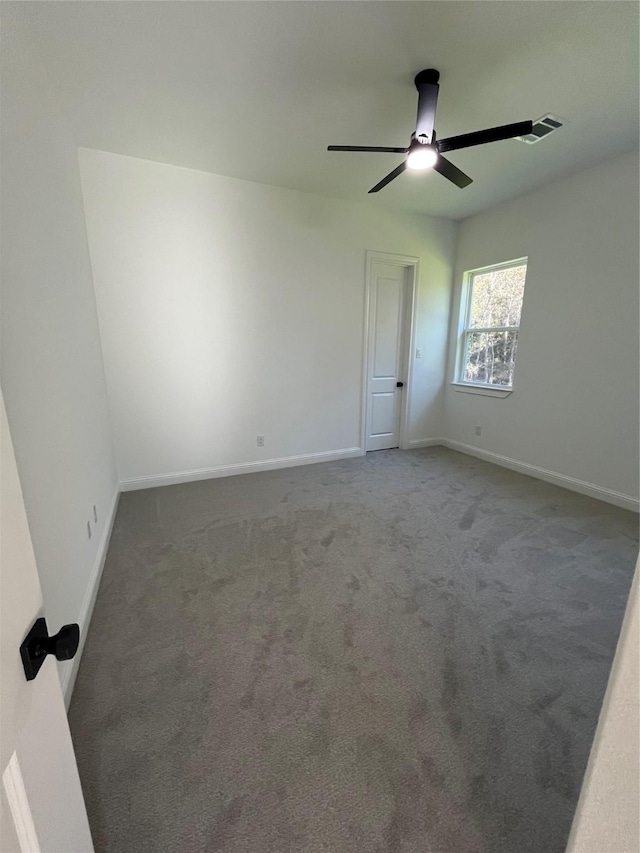 spare room featuring ceiling fan and carpet flooring