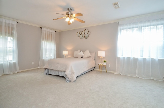 bedroom featuring ceiling fan, crown molding, and carpet