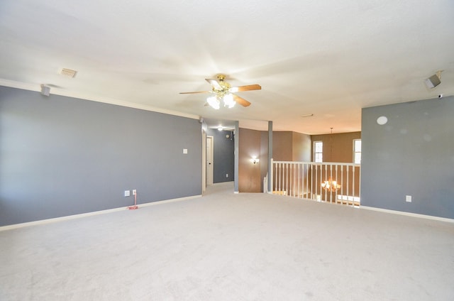 carpeted empty room with ceiling fan and crown molding