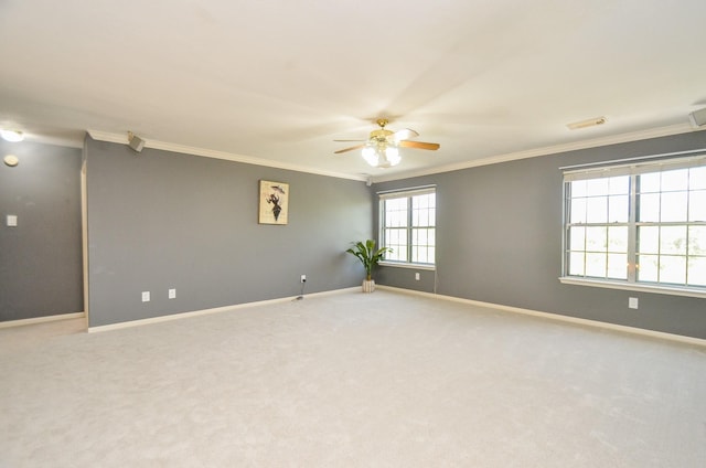 carpeted spare room featuring ceiling fan and ornamental molding