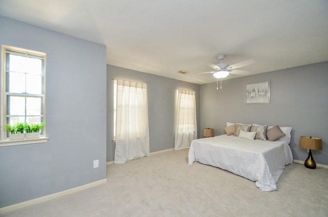 bedroom featuring light carpet and ceiling fan