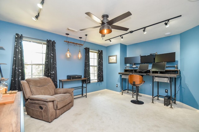 carpeted office featuring rail lighting, a wealth of natural light, and ceiling fan