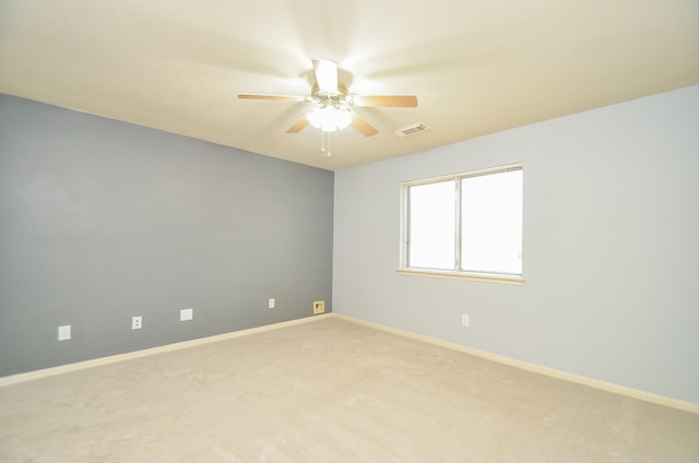 empty room featuring ceiling fan and light colored carpet