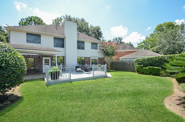 back of house with a yard and a deck