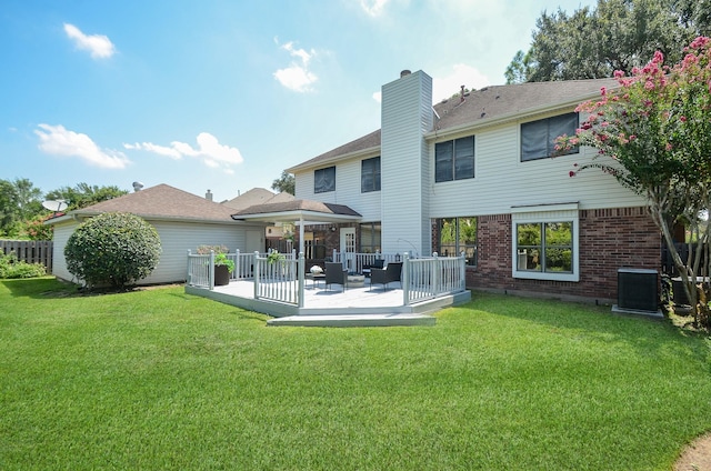 rear view of property with outdoor lounge area, cooling unit, a patio area, and a yard