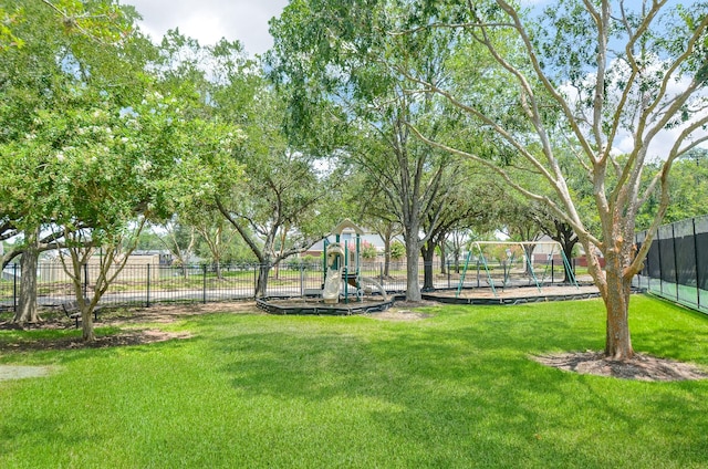 view of home's community with a playground and a lawn