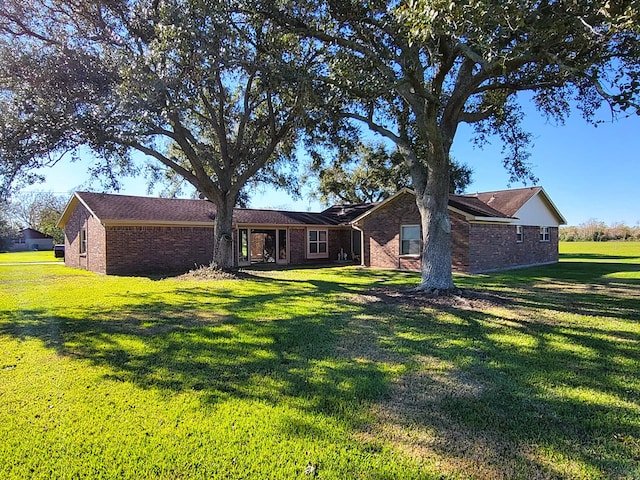 rear view of property with a yard