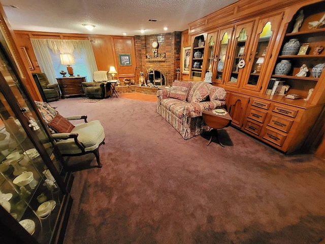 living room featuring a fireplace, a textured ceiling, and carpet floors