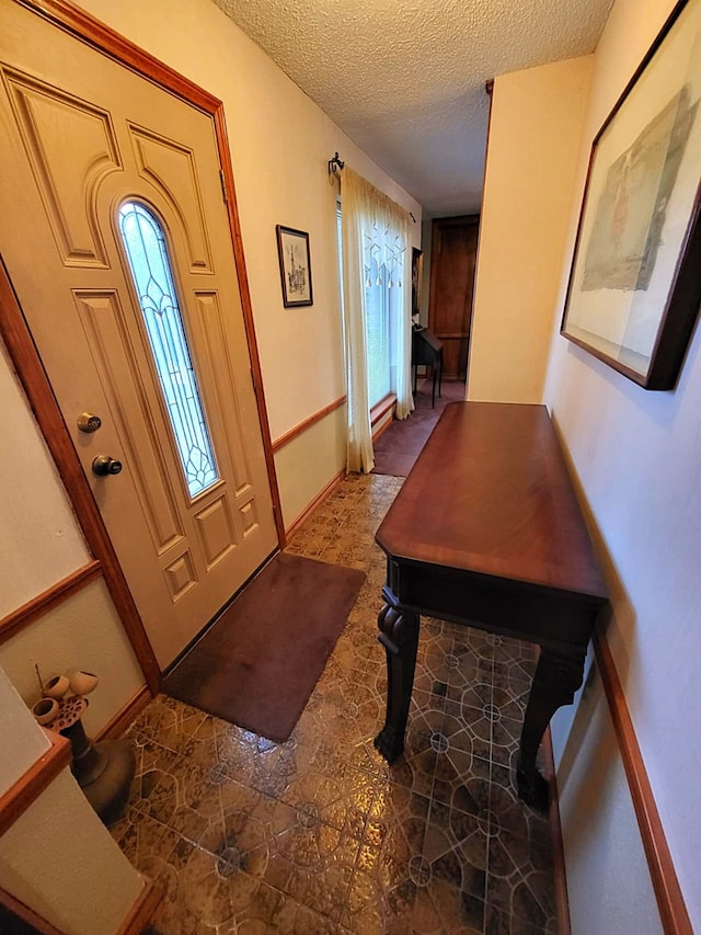 foyer with a textured ceiling