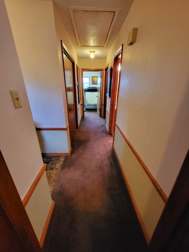 corridor with dark colored carpet