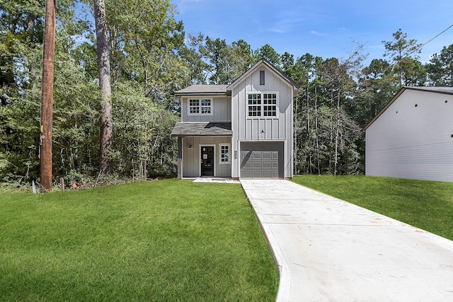 view of front of property with a garage and a front yard