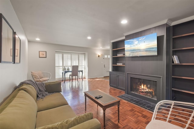 living room featuring parquet floors, ornamental molding, and a tiled fireplace