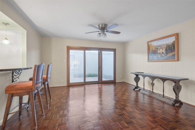 dining room featuring ceiling fan and dark parquet flooring