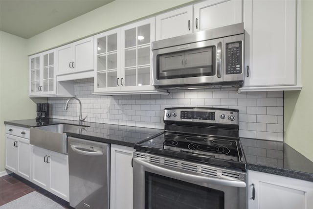 kitchen with white cabinets, stainless steel appliances, and tasteful backsplash