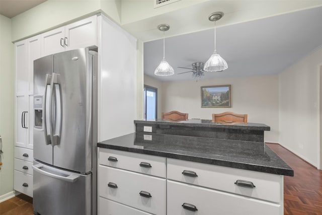 kitchen with kitchen peninsula, stainless steel refrigerator with ice dispenser, ceiling fan, decorative light fixtures, and white cabinetry