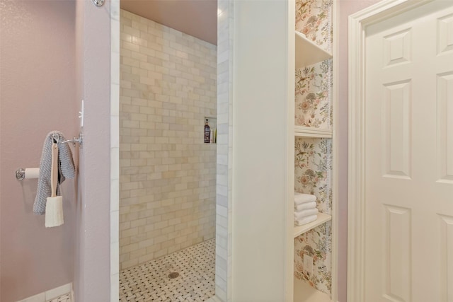 bathroom with a tile shower