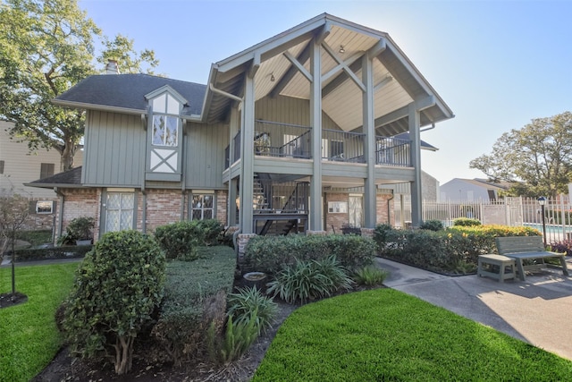 exterior space featuring a balcony and a yard